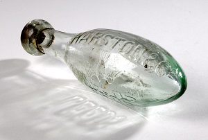 a glass bottle in an oblong shape.